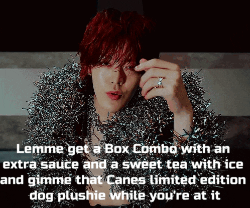 a man with red hair is wearing a tinsel coat and a ring on his finger