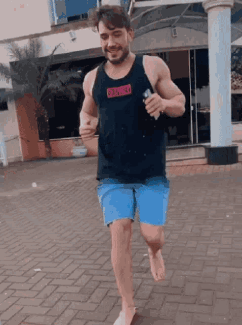 a man wearing a tank top that says south beach on it
