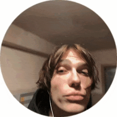 a man wearing headphones is taking a selfie in a circle with his face visible .