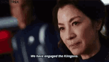 a woman is talking to a man and says `` we have engaged the klingons '' .