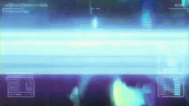 a person is standing in front of a computer screen with a blue light coming out of it .