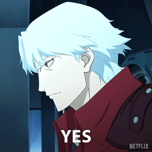 a man with white hair and a red jacket has the word yes on his chest