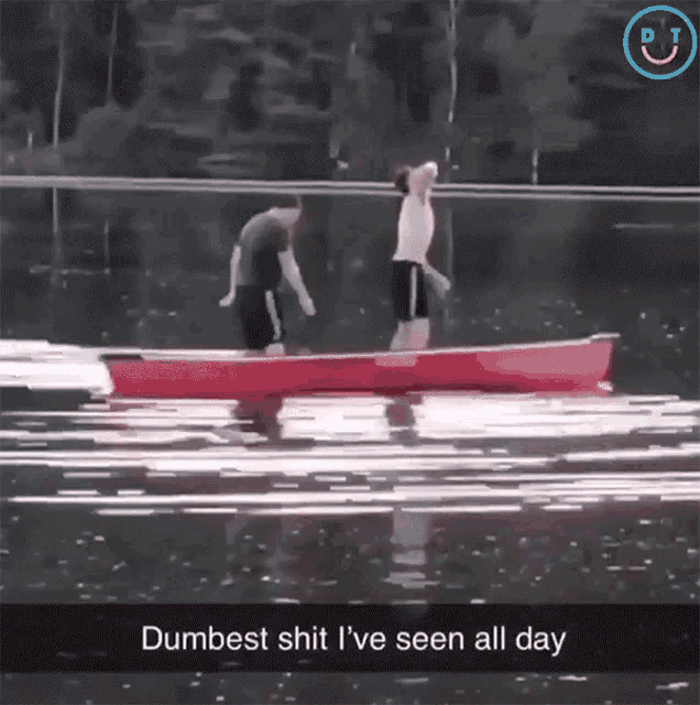 two men in a red canoe with the caption dumbest shit i ve seen all day
