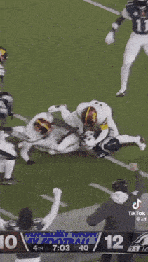 a football game is being played and the score is 10 12