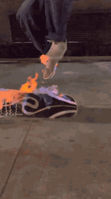 a person is riding a skateboard with flames on it