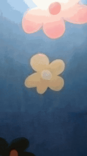a yellow flower with a white center is floating in the water