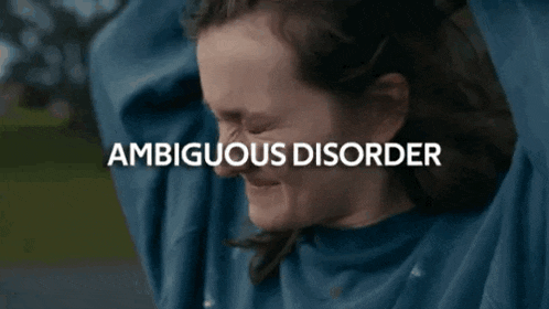 a woman is screaming with her eyes closed and the word ambiguous disorder is visible in the background .