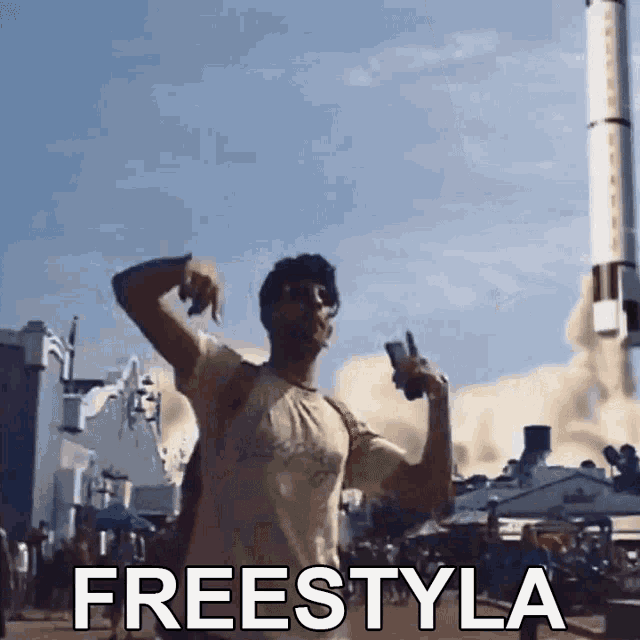 a man is holding a cell phone in front of a rocket and the word freestyle is on the bottom