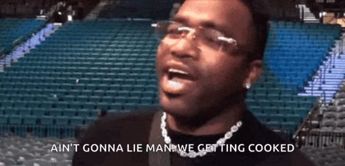 a man wearing glasses and a necklace says ain 't gonna lie man we getting cooked .