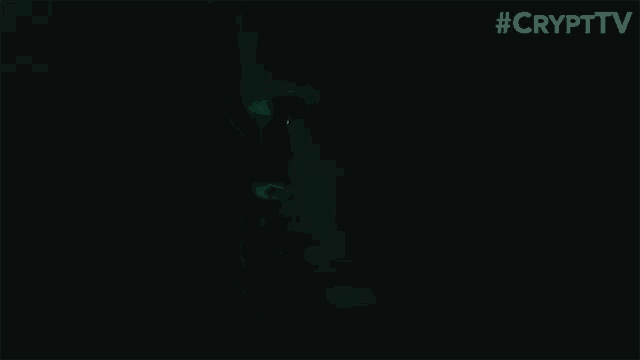 a close up of a person 's face in the dark with a green light coming out of his eyes .