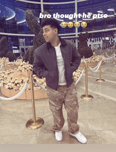 a man stands in front of a display of flowers with the caption bro thought he ptsd