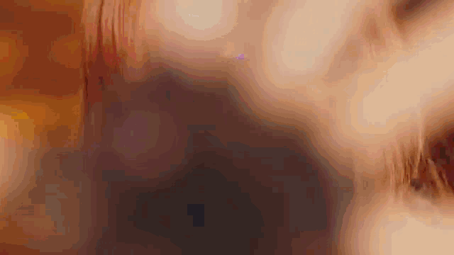 a close up of a person 's face with a cross on it