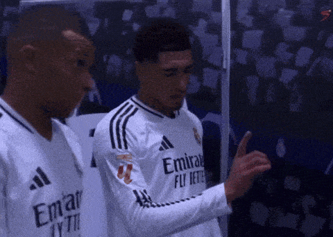 two soccer players wearing white jerseys with emirates fly better written on them