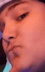 a close up of a person making a funny face with their mouth open .