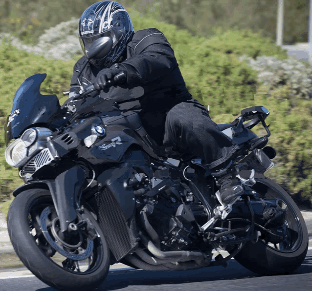 a man wearing a helmet is riding a motorcycle