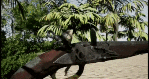 a close up of a gun with a hook on it in front of palm trees