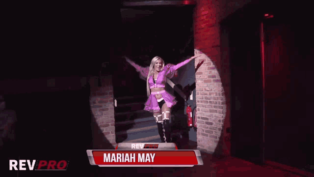 a woman in a pink dress is standing in a dark room with rev pro written on the bottom
