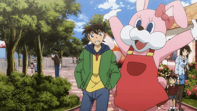 a pink bunny mascot is standing next to a boy