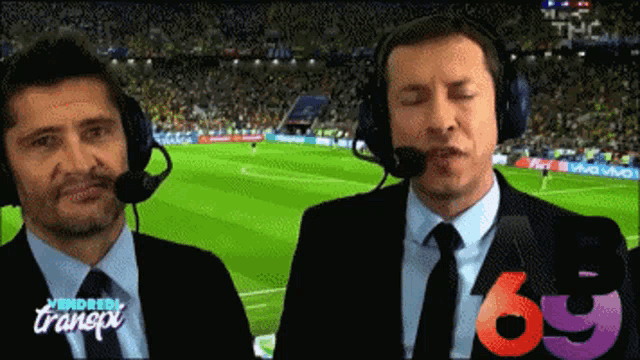 two men wearing headphones with the number 69 in the corner