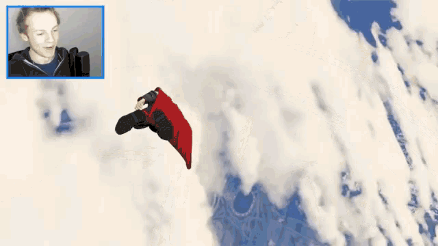 a man flying through the air with a red cape