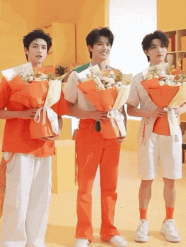 three young men are holding bouquets of flowers