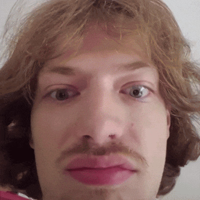 a close up of a man 's face with a mustache and pink lips