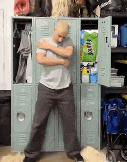 a man is standing in front of a locker that has a bag of bounty wipes in it