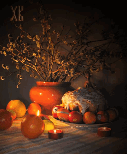 a picture of a table with fruit and candles with the letters xb on the top
