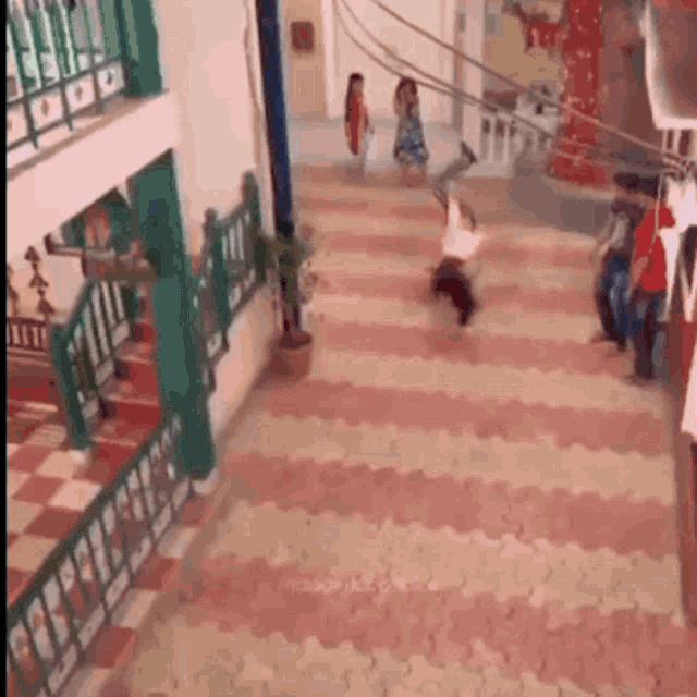 a person is doing a handstand on a rope in a room .