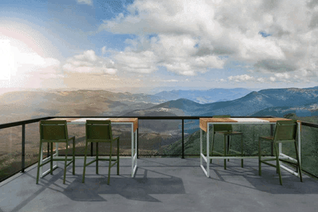 a balcony with a table and chairs with a view of mountains