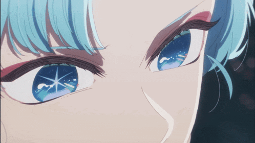a close up of a person 's eyes with a blue star in them