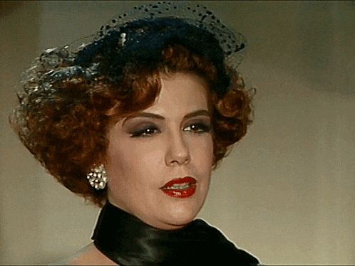 a woman with red hair wearing a black veil