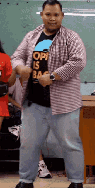 a man wearing a shirt that says opi is bag dancing