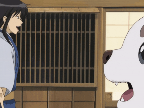 a man and a dog are standing next to each other in front of a window
