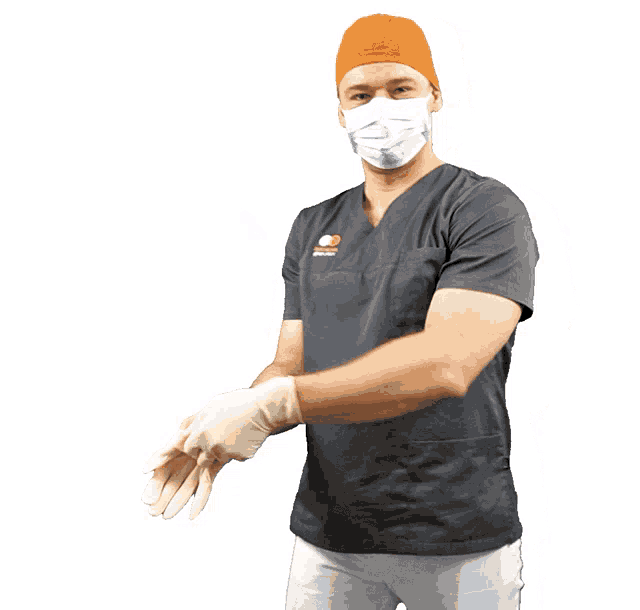 a surgeon wearing a mask and scrubs with the word dental on the front