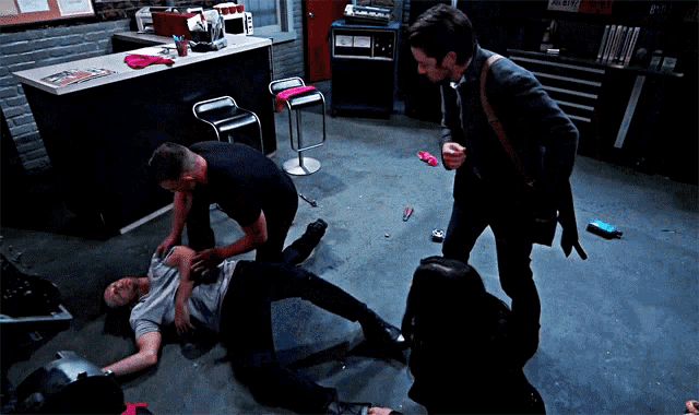 a man is laying on the floor in a room with a sign that says ' a & r ' on it