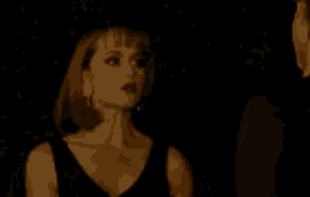a close up of a woman 's face with a dark background .