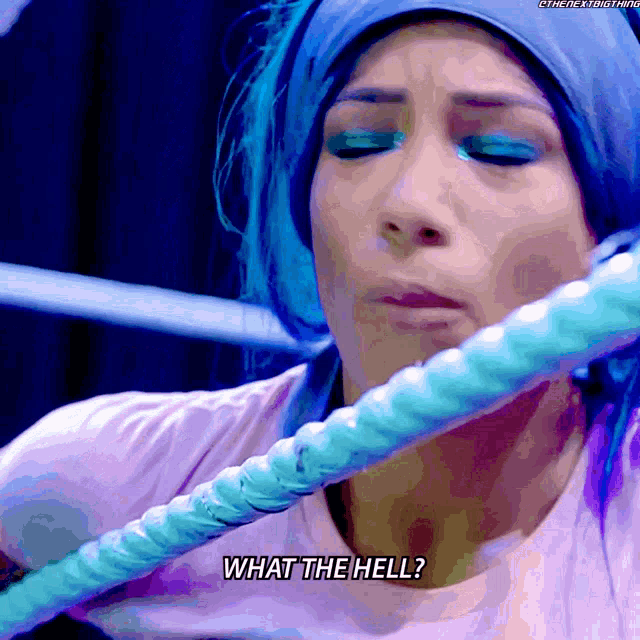 a woman with blue hair is holding a rope and asking what the hell
