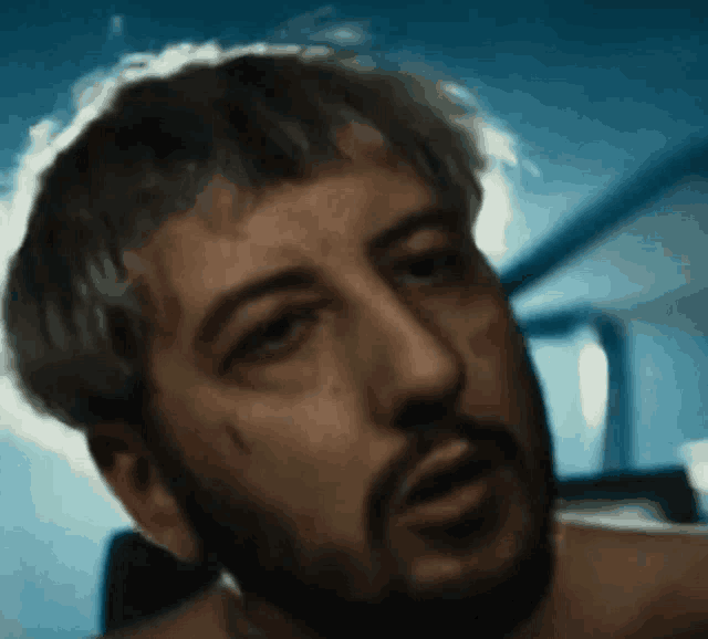 a close up of a man 's face with his eyes closed