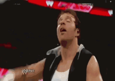 a man is standing in a wrestling ring wearing a black shirt that says w live on it .