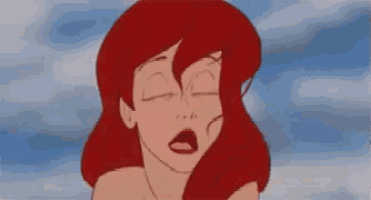 a close up of a cartoon character with red hair making a funny face with her mouth open .