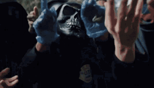 a group of people are holding a blue object in their hands while wearing gas masks .