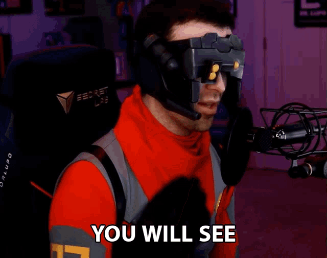 a man wearing a headset says " you will see " while standing in front of a microphone