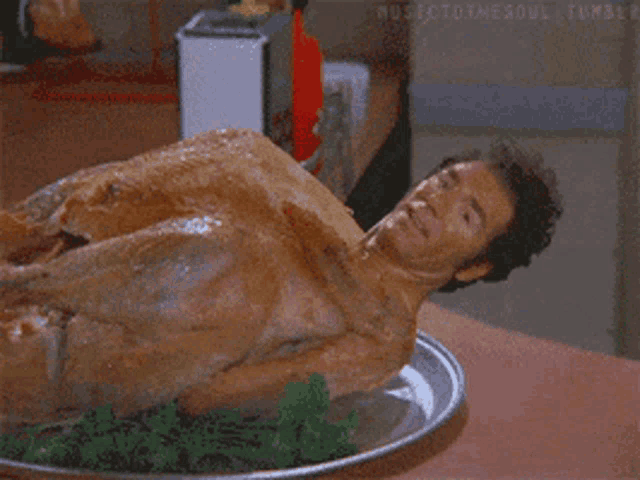 a naked man is laying on a plate of food