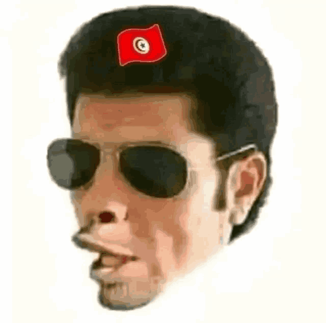 a man wearing sunglasses and a red hat with a flag on his head .