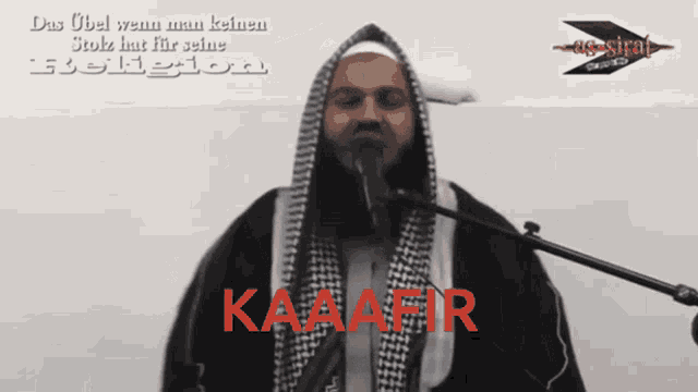 a man is singing into a microphone with the word kaaafir in red