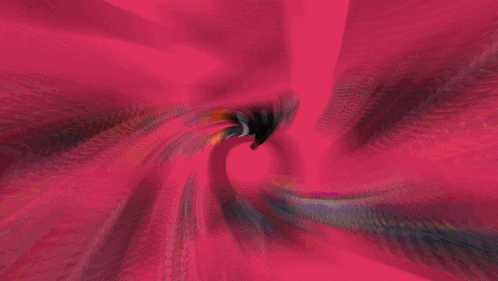 a blurred image of a person standing in front of a pink object