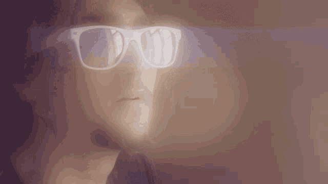 a man wearing a pair of white sunglasses looks at something