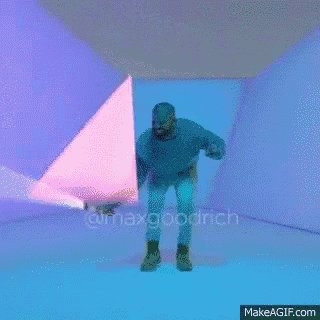 a man in a black hoodie is holding a light saber in front of a pink background .