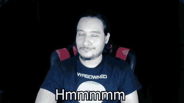 a man wearing a black shirt that says wasowned on it